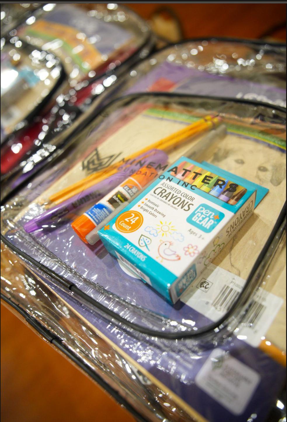 A Minematters-branded school supply kit with crayons, glue and pencils